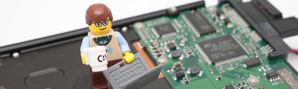 lego character with coffee mug and laptop