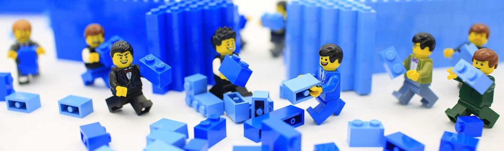 lego characters moving small bits of blue lego
